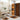 Bathroom with orange and black patterned shower curtain and bath mats.