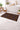 Decorative bath mat with geometric pattern in a bathroom setting
