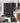 Bathroom with black and white patterned shower curtain, rug, and toilet mat.