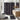 Bathroom with black and white patterned shower curtain, rug, and toilet mat.