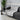 Gray sofa with a black and white patterned throw blanket in a modern living room.
