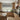Modern kitchen with wooden cabinets, a window with a black and white patterned valance, and various kitchen items.