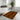 Bathroom with a patterned orange and black rug on the floor.