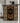 Decorative doormat with geometric pattern hanging on a black rod in a bathroom.