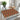 Decorative placemat with geometric pattern on a glass table with a teapot and cup.