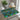 Geometric patterned placemat on a glass table with a teapot and cup in the background.