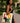 Woman holding a tote bag with 'LOVE Africa' design in an outdoor setting