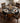 Dining table set with a black and orange geometric patterned tablecloth and chairs.