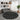 Round black rug with white patterns in a living room setting
