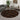 Round patterned rug in a living room with a sofa, coffee table, and decorative items.