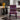 A modern dining chair with a vibrant geometric tribal pattern in black, red, purple, and white, set in a contemporary living room environment.