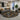 Living room with a geometric patterned rug, gray sofa, and cityscape view.