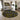 Living room with a round black rug featuring yellow and white patterns, a gray sofa, and abstract wall art.
