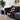 Decorative blanket with tribal patterns draped over a gray sofa in a living room.