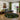 Living room with a gray sectional sofa, round patterned rug, and decorative elements.