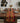 Dining table set with a patterned table runner, chairs, and decor in a modern room.