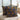 Two patterned pillows on a light-colored surface with a neutral background
