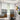 Living room with patterned curtains and abstract art on the wall