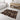 Patterned rug on a bathroom floor with a bathtub and vanity in the background