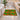 Colorful patterned rug on a bathroom floor with a bathtub and sink in the background.