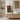 Bathroom with wooden vanity, mirror, and patterned towel.