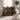 Two square throw pillows with a bold African tribal geometric pattern in black, mustard yellow, and white, styled on a beige fabric sofa in a bright, modern living room.
