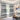 Living room with black and white patterned curtains, a sofa, and a colorful abstract painting.
