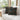 Two geometric patterned pillows on a white couch in a bright room with large windows.
