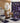 Bathroom with purple and black patterned shower curtain, rug, and toilet cover.