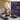 Bathroom with purple and black patterned shower curtain, rug, and toilet cover.