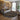 Living room with a patterned afro round rug, sofa, and decorative elements.