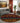 Living room with a patterned rug, gray sofa, and decorative elements.