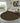 Round patterned rug in a modern living room with a sofa and decor.