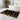 Patterned bath mat on a marble floor in a bathroom setting