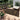 African Patterned outdoor rug on a wooden deck with furniture and plants.