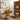 Bathroom with patterned shower curtain, toilet seat cover, and rug