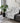Black and white patterned throw blanket draped over a gray sofa in a living room setting.